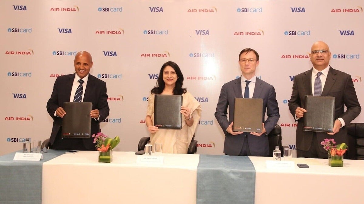 Air India, SBI Card and Visa executives hold signed partnership folders at the co-brand credit card announcement in Mumbai