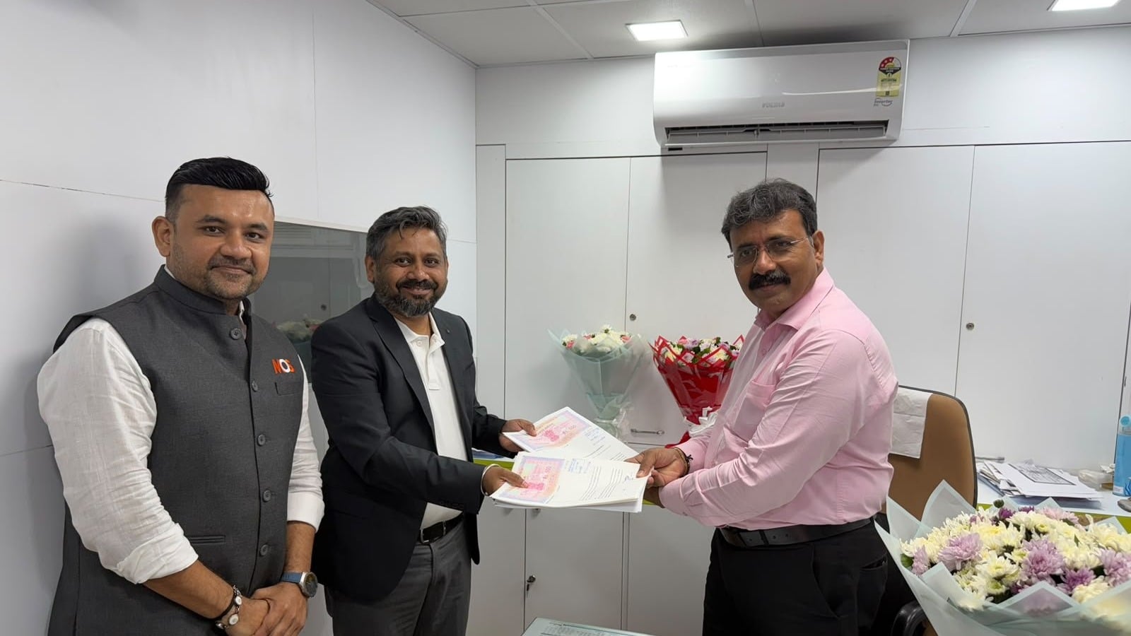 MOS Utility and Bharat Co-operative Bank (Mumbai) officials exchanging partnership documents